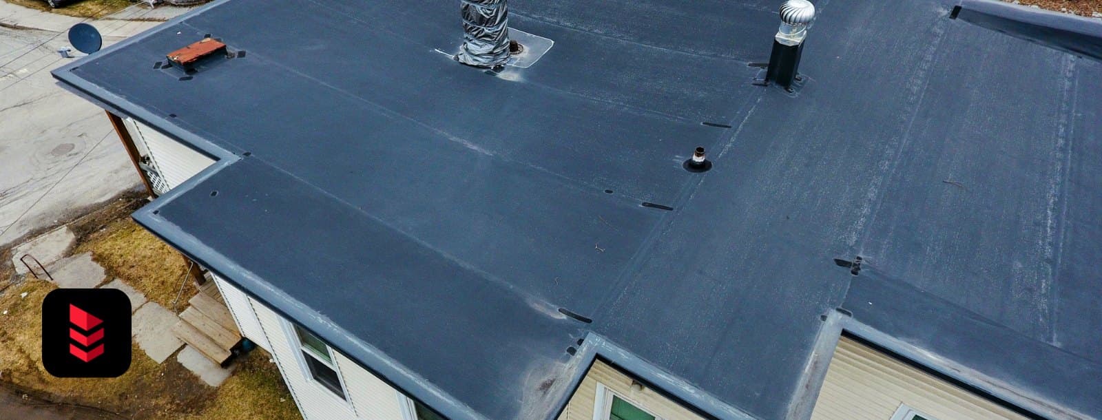 Finished black EPDM rubber flat roof on an apartment building